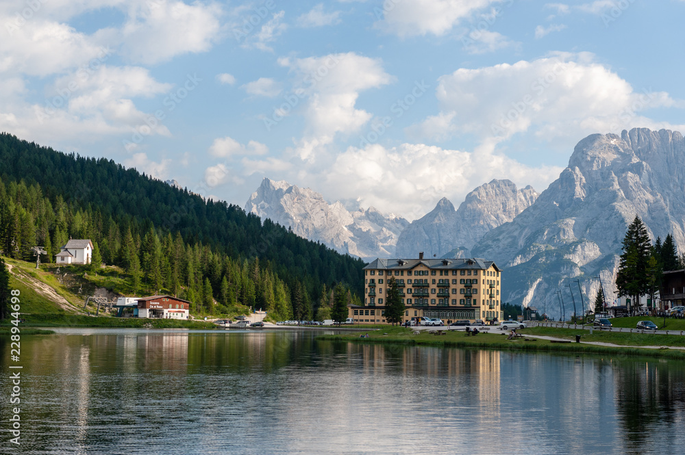 Imression of the buildings along the shoreline of Lake Misurina, in the Italian Dolomites, on a Summer's Afternoon.