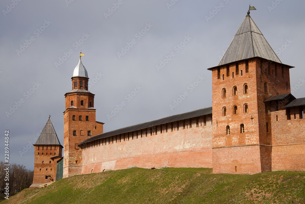 Three medieval defensive towers of the Kremlin of Veliky Novgorod on a cloudy April day. Russia