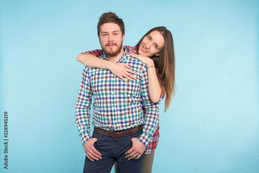 Portrait of cheerful funny young lovers on blue background Portrait of cheerful funny young lovers on blue background