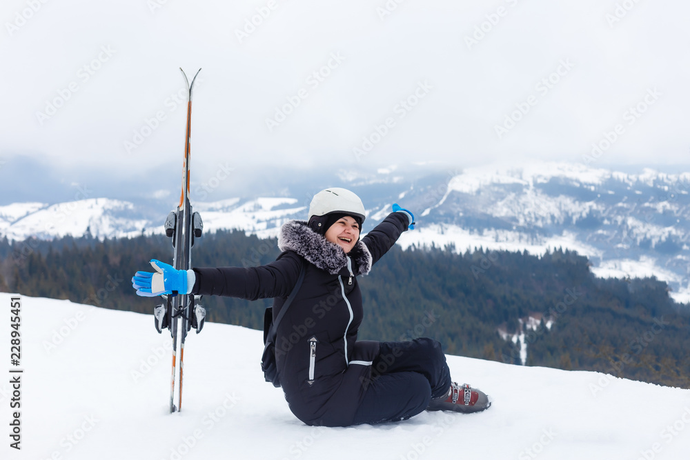 Female skier having fun on the top of ski slope