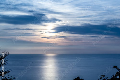 Sunset from Karon Viewpoint, Phuket Thailand with a very blue sky.