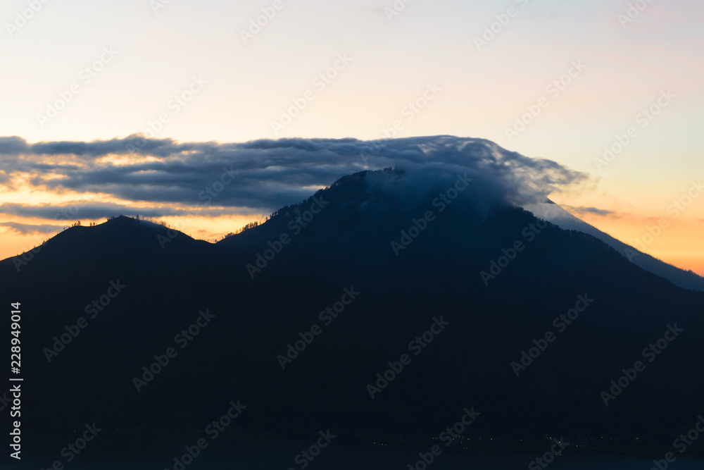 Sunrise view from Gunung Batur volcano in Bali with visible Mount Agung volcano Sunrise view from Gunung Batur volcano in Bali with visible Mount Agung volcano