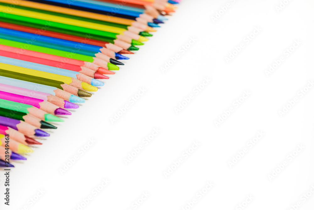 Fototapeta premium colored pencils in a row on a white background, creativity