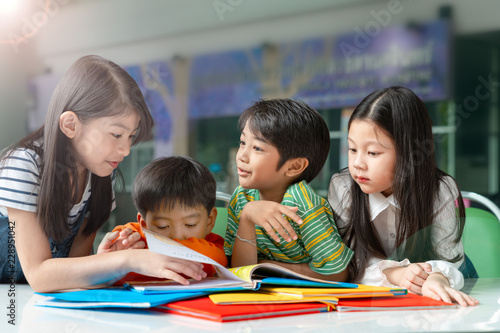 Asian Little Children Reading Book Cheerful