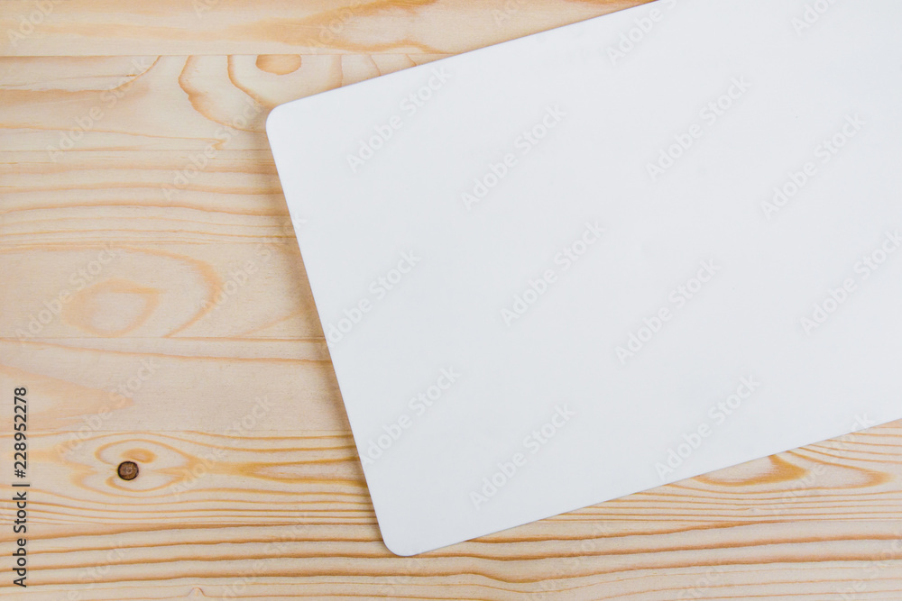 clean white sheet with rounded edges on a light-colored wooden background clean white sheet with rounded edges on a light-colored wooden background