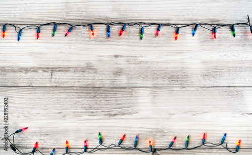 Christmas lights bulb decoration on white wood plank. Merry Christmas and New Year holiday background. vintage color tone.