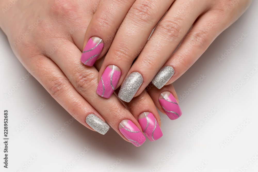 Pink moon manicure with silver glitter with silver waves, stripes on long square nails close-up
Pink moon manicure with silver glitter with silver waves, stripes on long square nails close-up