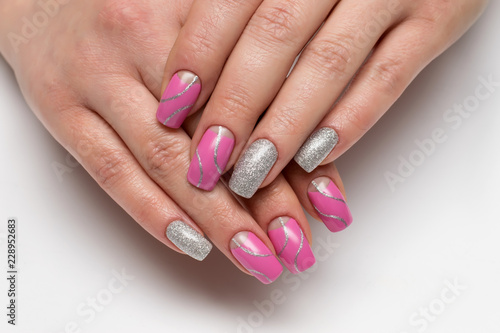 Pink moon manicure with silver glitter with silver waves, stripes on long square nails close-up