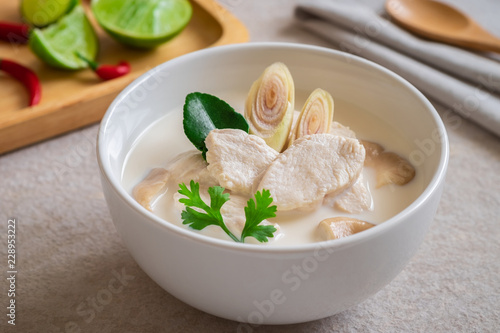 Chicken with coconut milk soup in white bowl, Thai food (Tom Kha kai).