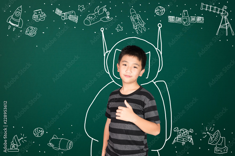 Asian kid with his imagination about science and space adventure, hand drawn on the green chalkboard, education back to school and discovery concept.