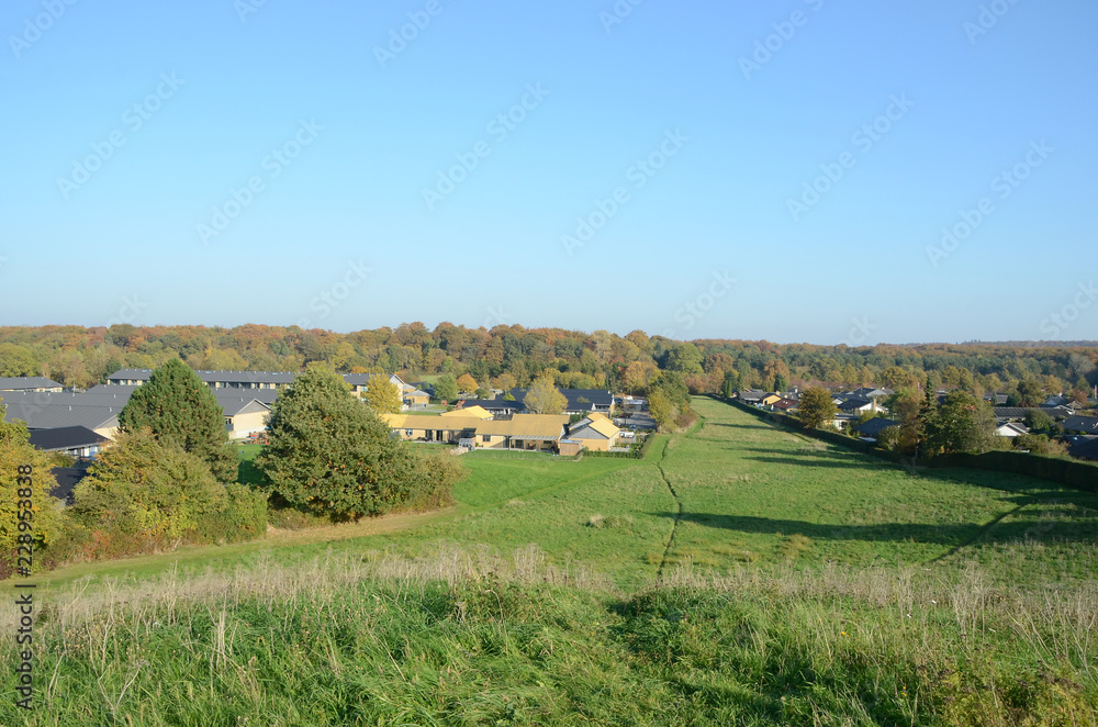 View over a landscape with a settlement.
