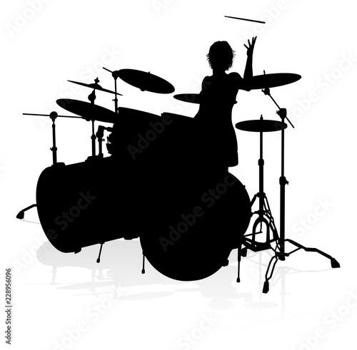 A drummer musician drumming drums in detailed silhouette