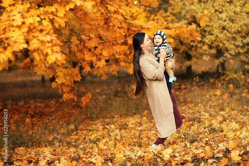 mother with son in autumn park