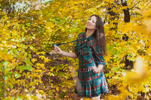 Portrait of Young Fashion Woman Outdoor on Autumn Background