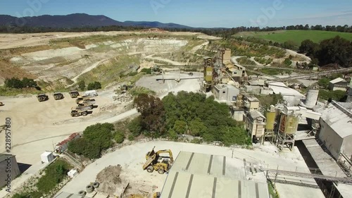 Forward flight over decommissioned limestone mine factory and quarry pit