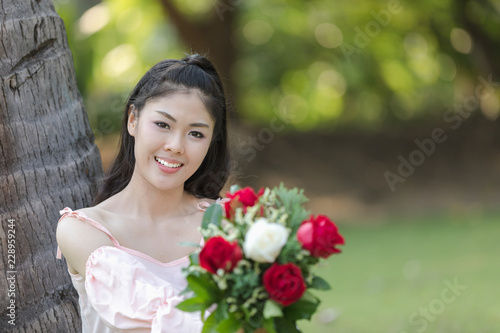young woman asian girl with roses red smiling hoppy in valentines day