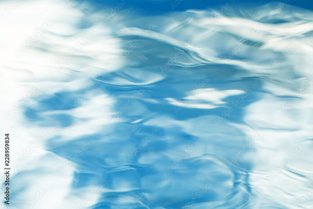 The smooth natural blue water background with bokeh  abstract on the sea or ocean,vintage and soft colored blur.