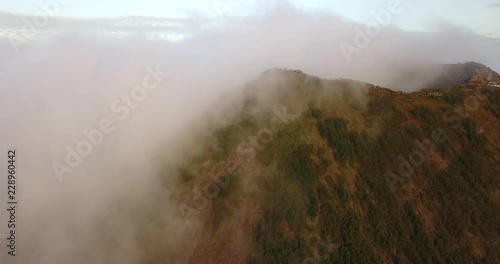 flying to the top of the Batur volcano with many tourists through clouds, Bali