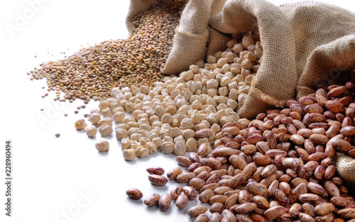 Dried legumes. Pinto beans, chickpeas and lentils on white background