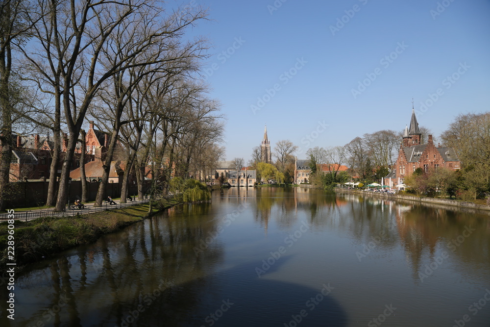 Canal of Bruges with old traditional houses. Canal of Bruges with old traditional houses.