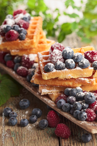  Yummy sweet waffles with raspberries and blueberries.