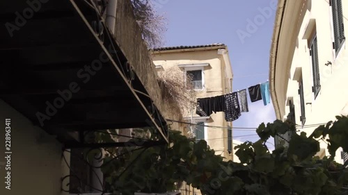 Clothes hanging out to dry after cleaning in traditional old town in Corfu Greece