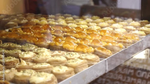 Delicious jam and cream filo pastry pastries in the window of a Greek bakery shop 