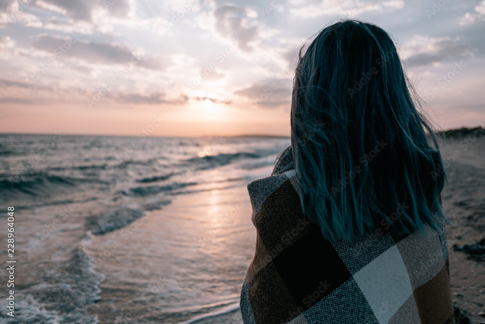 Woman enjoying view of sunset on sea coast. Woman enjoying view of sunset on sea coast.