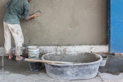 workers are plastered at the wall © chalongrat