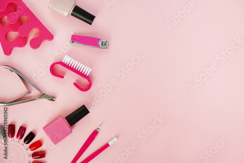 flat lay of manicure and pedicure tools on pink table
