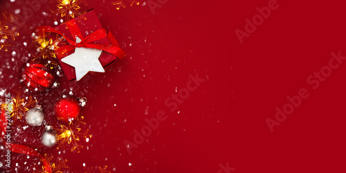 Christmas and New Year holiday background. Xmas greeting card. Christmas gifts on red background top view.