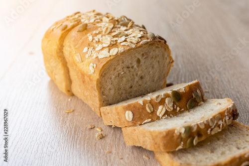 Close up multi grain bread sliced on wood table