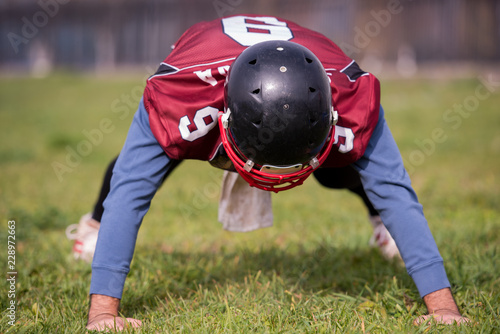 american football player doing push ups