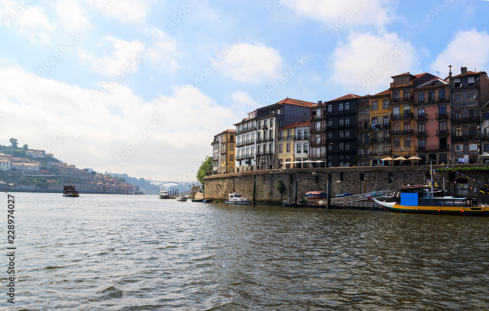 View of the Ribera from the water, Porto, Portugal. Colorful houses on the embankment of the river Douro.