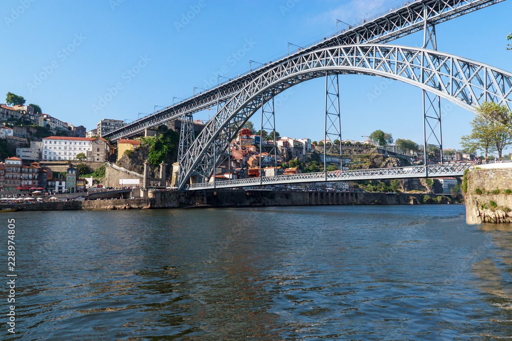 Scenic view of the bridge Dom Luis I Bridge from Vila Nova de Gaia. The river Douro, Porto, Portugal on the summer sunny day.