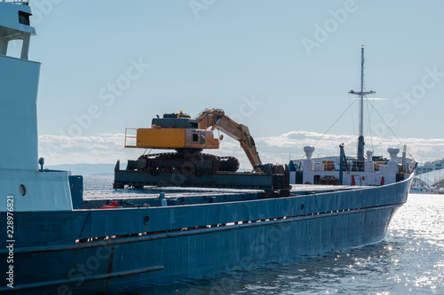Cargo ship. Large container vessel unloaded. Excavator on a ship. Oslo, Norway