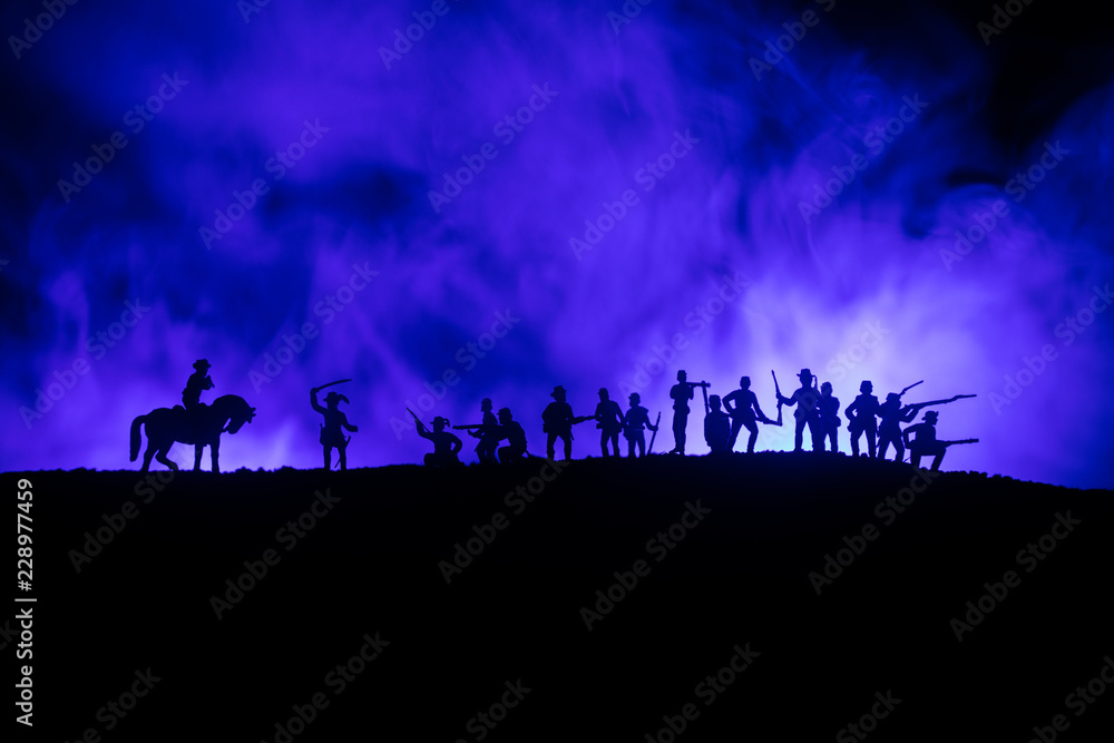 Fototapeta premium American Civil War Concept. Military silhouettes fighting scene on war fog sky background. Attack scene.