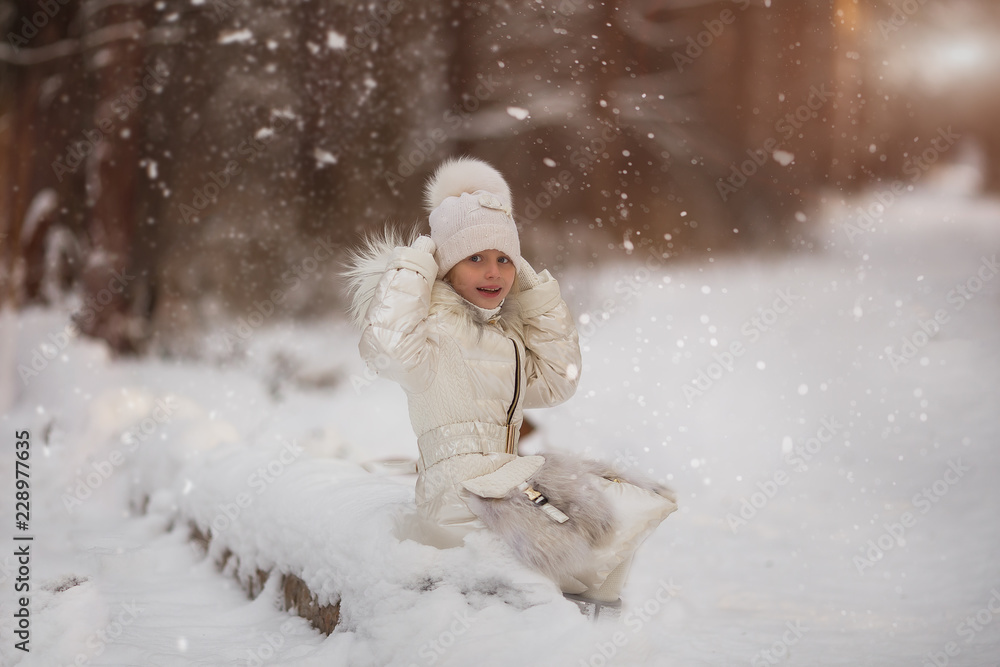 Sweet beautiful girl enjoying falling snowflakes in the park for a walk Sweet beautiful girl enjoying falling snowflakes in the park for a walk