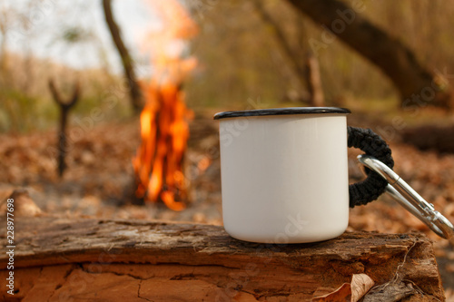 Camping mug in autumn forest