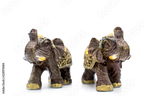 Figurines of indian elephants on a white background