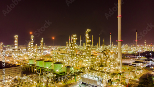 Oil storage tank with oil refinery background, Oil refinery plant at night.Aerial view from drone top view