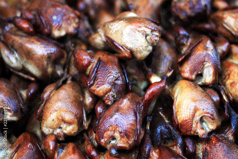 grilled quails in a pile grilled quails in a pile