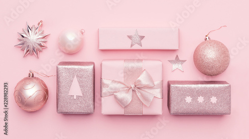 Pastel pink minimal christmas banner. Beautiful nordic christmas gifts isolated on pastel pink background. Pink colored wrapped xmas boxes composition. photo