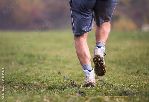 american football player exercises on ladder drills