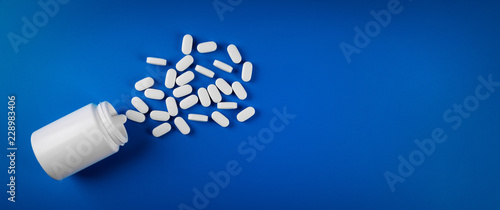 medical pills on blue background. top view copy space photo