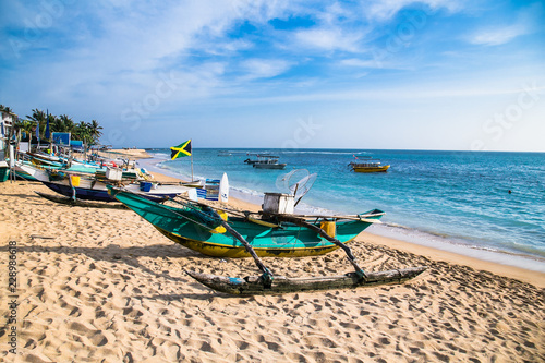 Fishing boats on Unawatuna beach, Sri Lanaka. photo