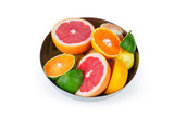 Different partly cut citrus in metal bowl