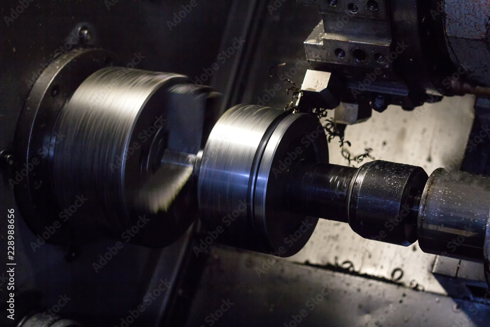 CNC lathe pulls out part of metal workpiece pulley, modern lathe for metal processing, close-up, metalworking