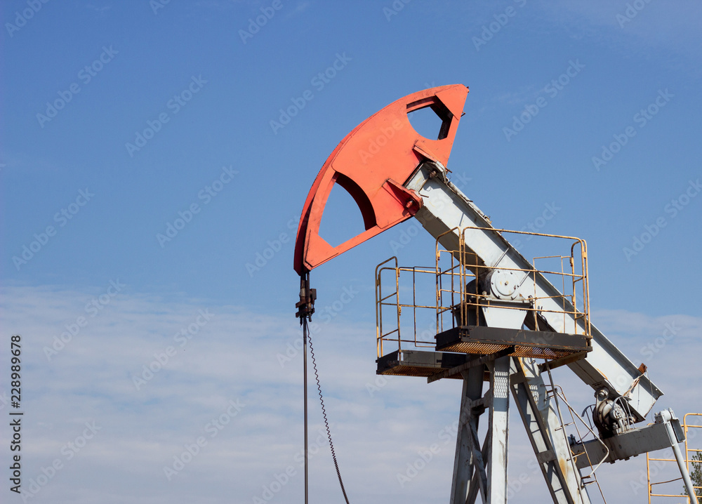 Oil well gas and gasoline well against the blue sky, close-up, Extraction of petroleum, equipment, extraction, environment Oil well gas and gasoline well against the blue sky, close-up, Extraction of petroleum, equipment, extraction, environment