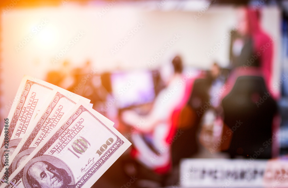 Money dollars against the background of a TV on which e-sports are shown, sports betting, money dollars